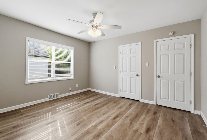 Unfurnished bedroom with light wood-style floors and ceiling fan