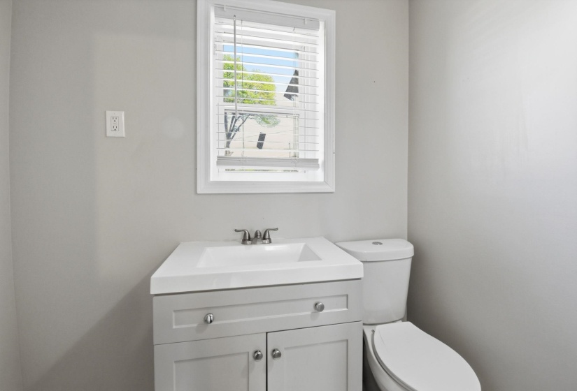 Half bath featuring vanity and toilet