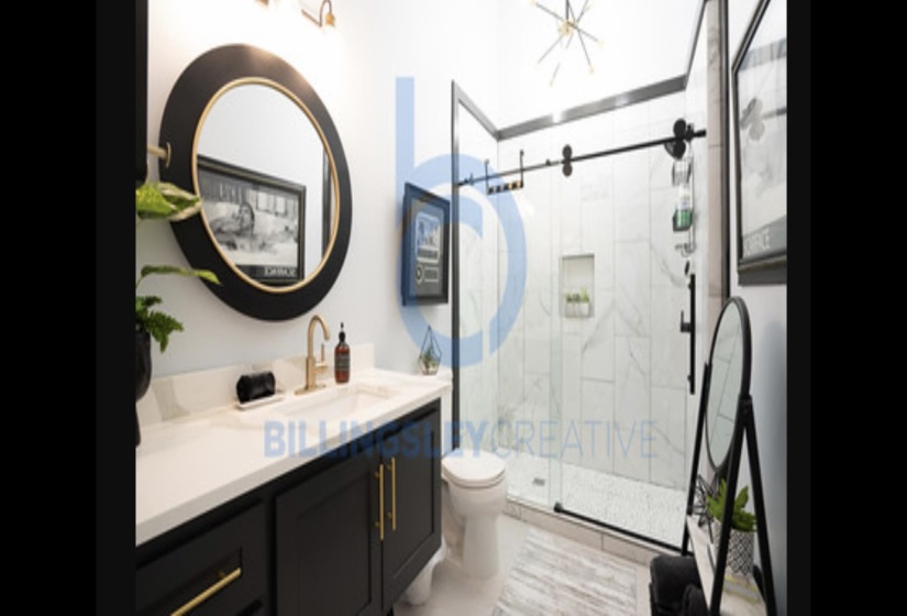 Full bath featuring vanity and a marble finish shower