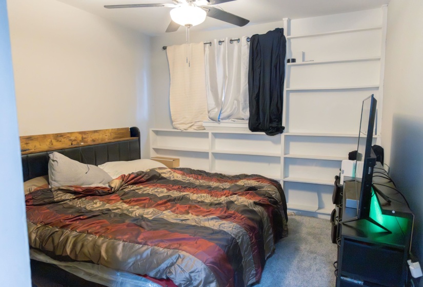 Carpeted bedroom with ceiling fan