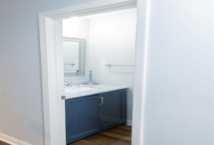 Bathroom with vanity and dark wood-type flooring