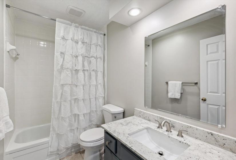 Bathroom featuring vanity and shower / bath combo with shower curtain