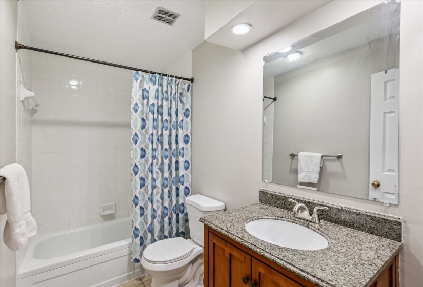 Bathroom with vanity and shower / bath combination with curtain