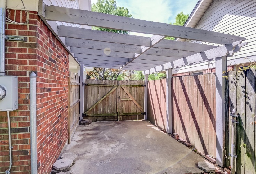 View of patio with a pergola and a gate