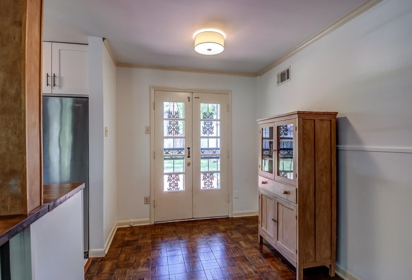 Doorway featuring ornamental molding, french doors, and parquet flooring