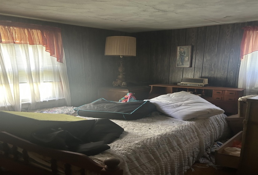 Bedroom featuring wooden walls