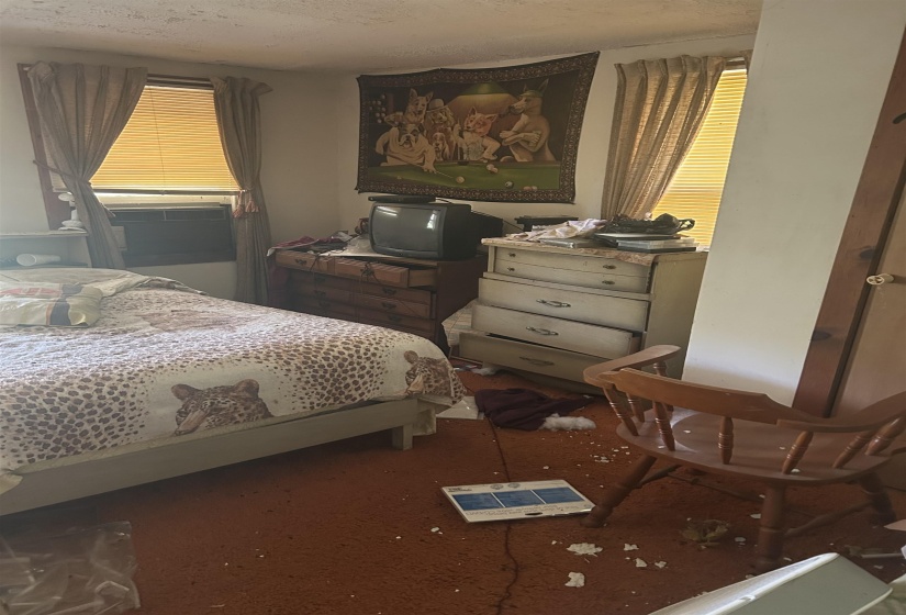 Carpeted bedroom with a textured ceiling