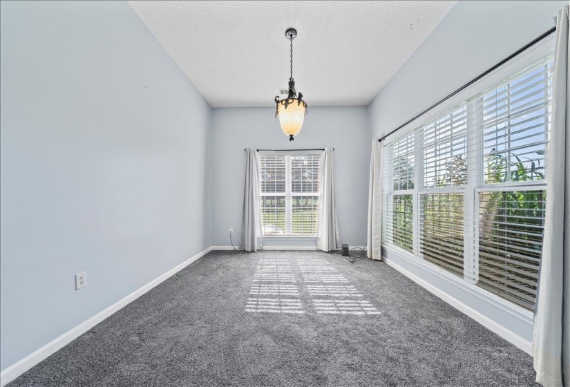 Empty room with carpet and a textured ceiling