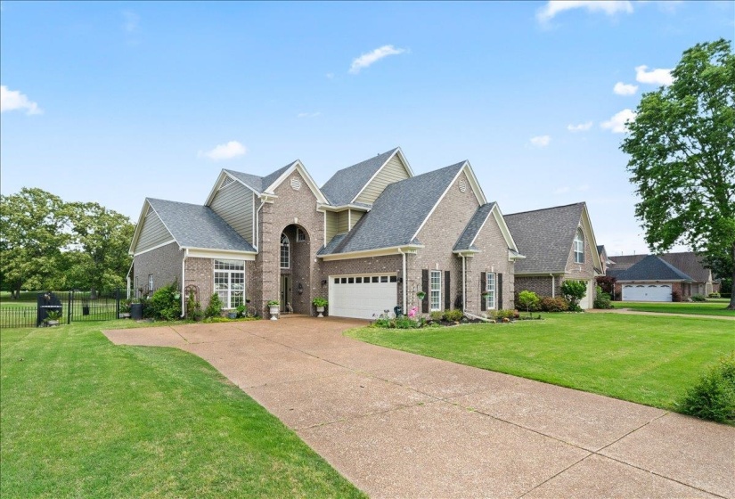 Brick and siding exterior featuring multiple gables and dark shingle roofing