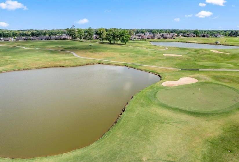 Expansive golf course setting featuring multiple greens and sand traps