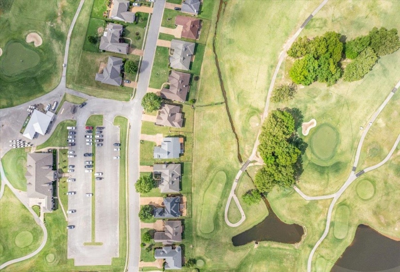 Aerial perspective showcasing a residential community bordering a golf course
