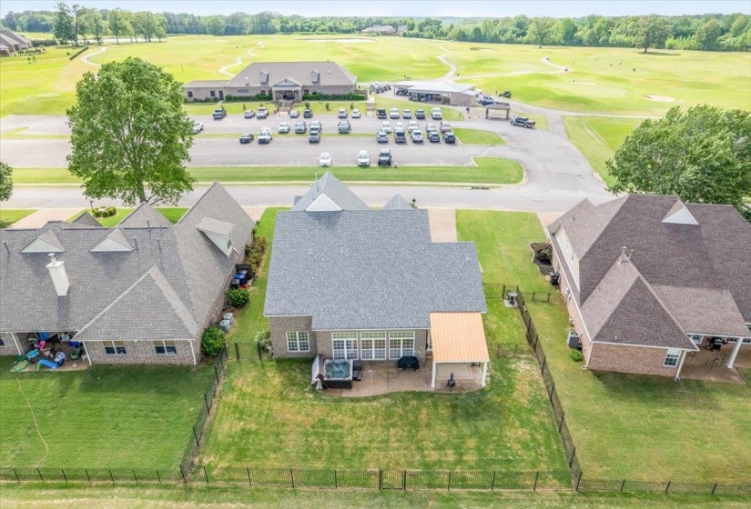 Drone / aerial view of a local golf course and a tree filled landscape