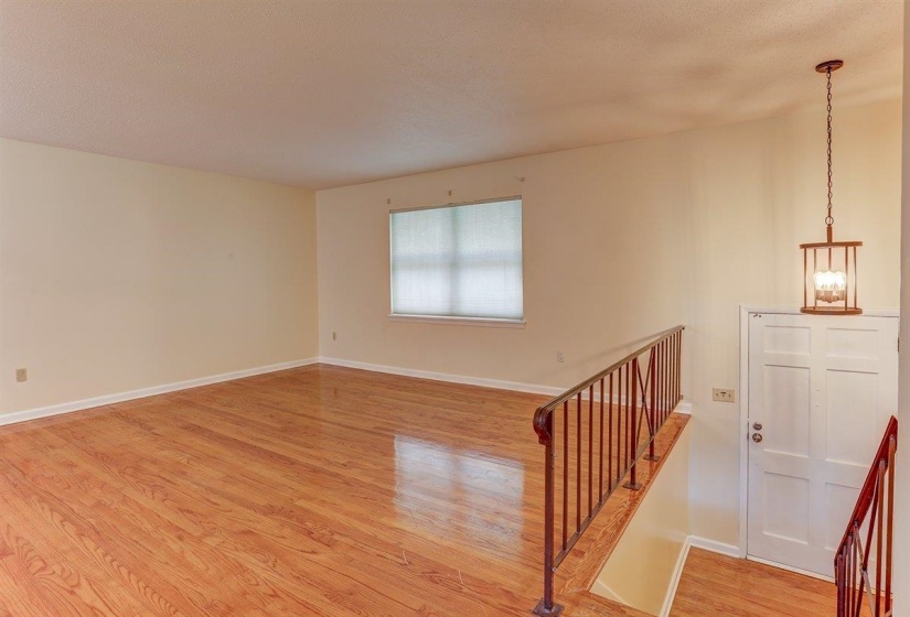 Spare room featuring light wood-type flooring and a textured ceiling