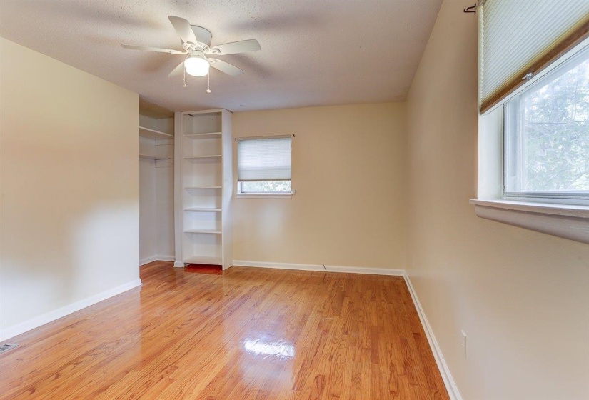 Unfurnished bedroom with light wood-style floors, a closet, ceiling fan, and a textured ceiling