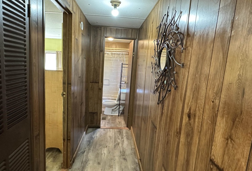 Hallway with wooden walls and wood finished floors