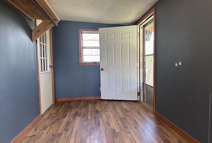 Entryway with dark wood-style floors and baseboards