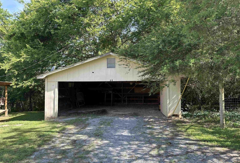 Two-car open garage with white siding and a gable roof