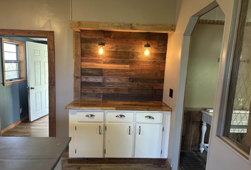 Kitchen featuring white cabinetry, dark wood finished floors, and butcher block countertops