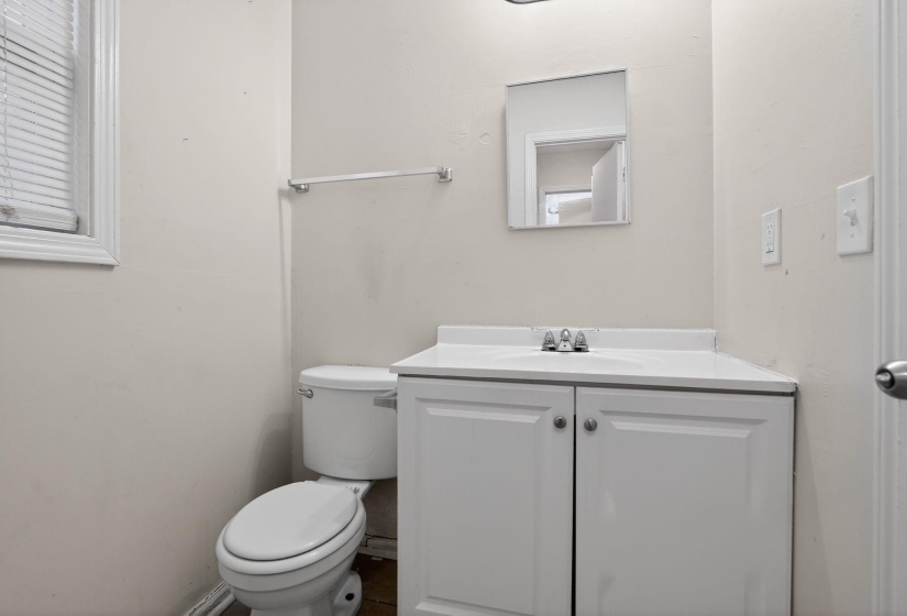 Half bathroom with vanity and toilet