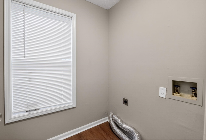 Laundry room with hookup for an electric dryer, washer hookup, and dark wood finished floors