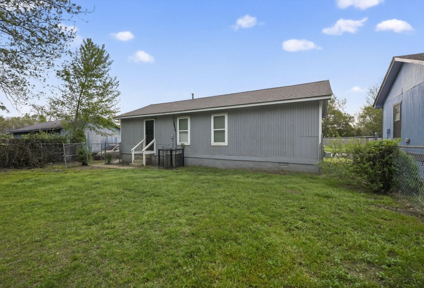Back of house featuring a fenced backyard