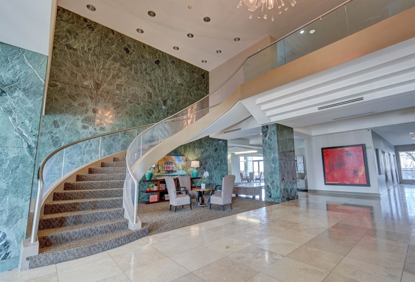 Community lobby with stairs and a high ceiling