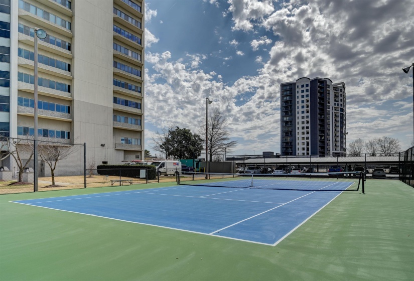 View of tennis court featuring community basketball court