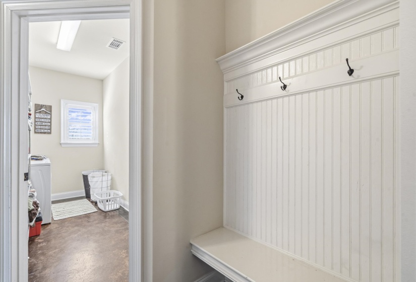 Mudroom with concrete floors and washer / dryer