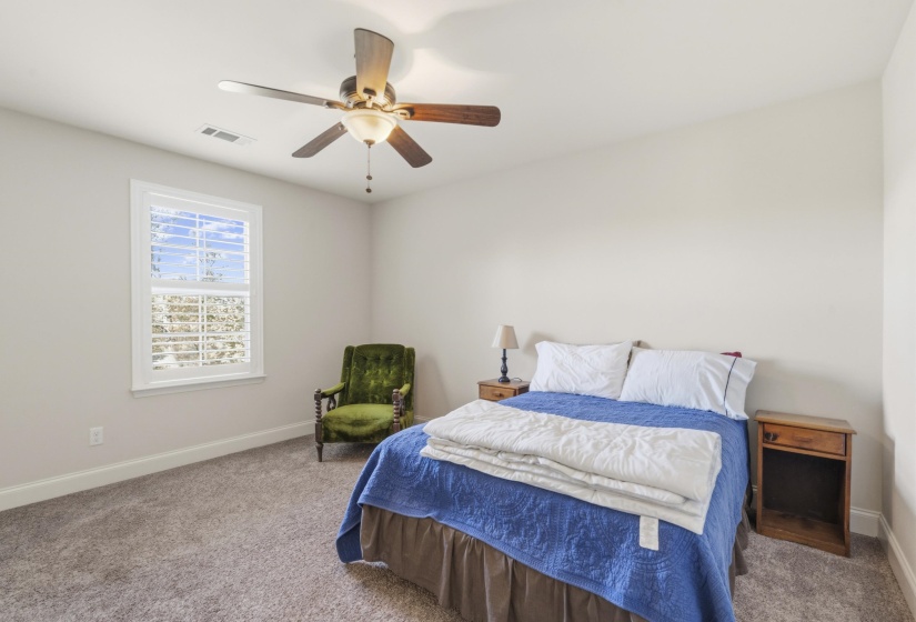 Bedroom with a ceiling fan and carpet