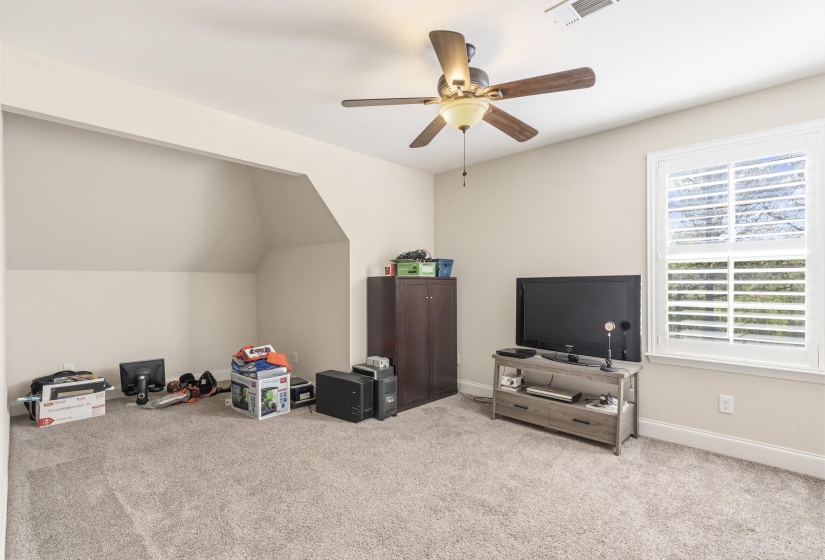 Game room featuring light carpet, ceiling fan, and vaulted ceiling