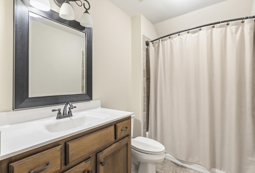 Bathroom with vanity and shower / tub combo with curtain