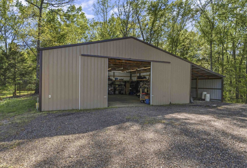 View of pole building featuring gravel driveway