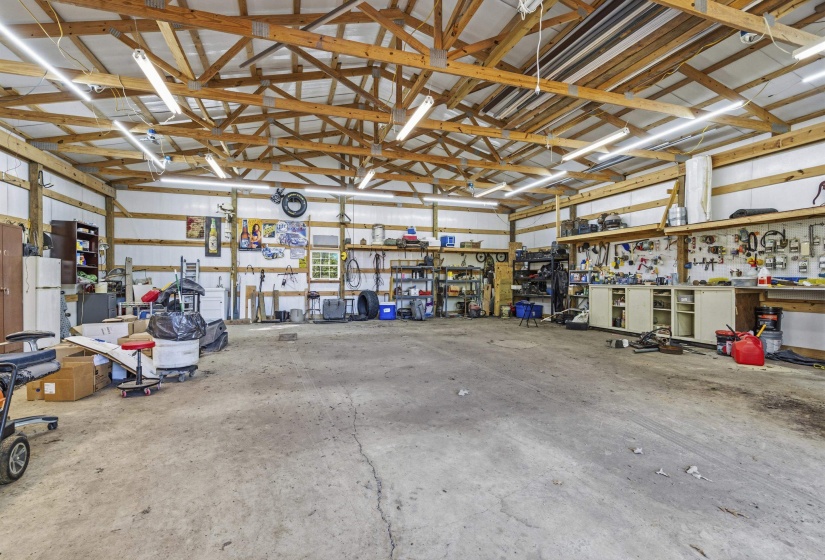 Garage with a workshop area and freestanding refrigerator