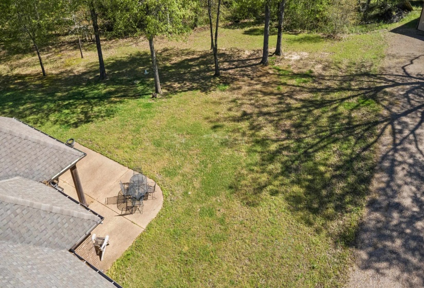View of green lawn with a patio
