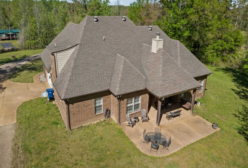 View from above of property with a tree filled landscape