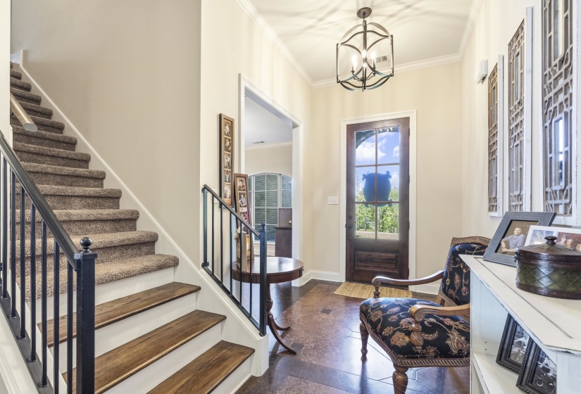 Entrance foyer featuring crown molding and a chandelier