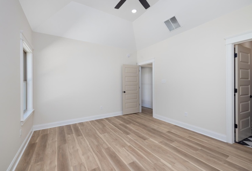 Unfurnished bedroom with vaulted ceiling, light wood-style flooring, ceiling fan, and recessed lighting