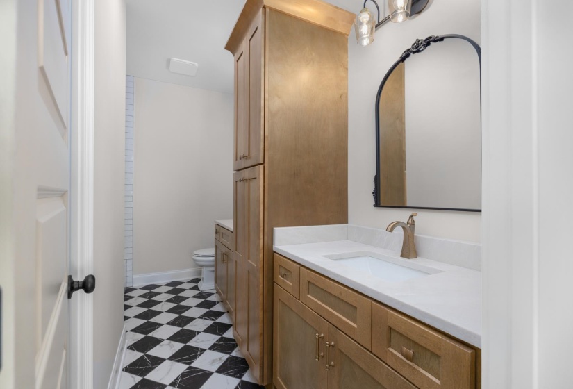 Full bathroom with light flooring and vanity