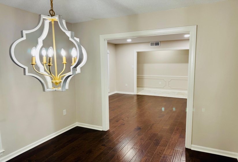 Interior space with an inviting chandelier and hardwood / wood-style flooring