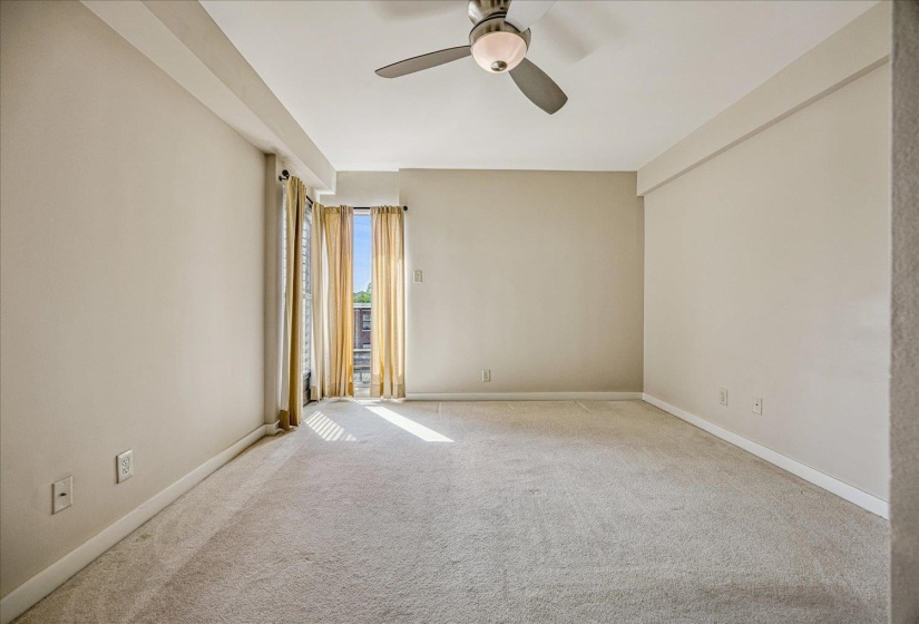 Spare room featuring carpet and a ceiling fan