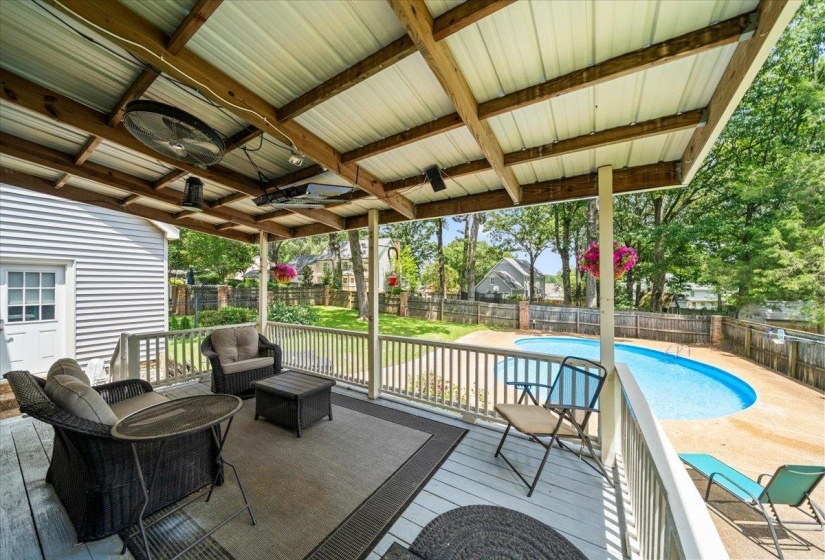 Fenced backyard featuring a deck and an outdoor living space