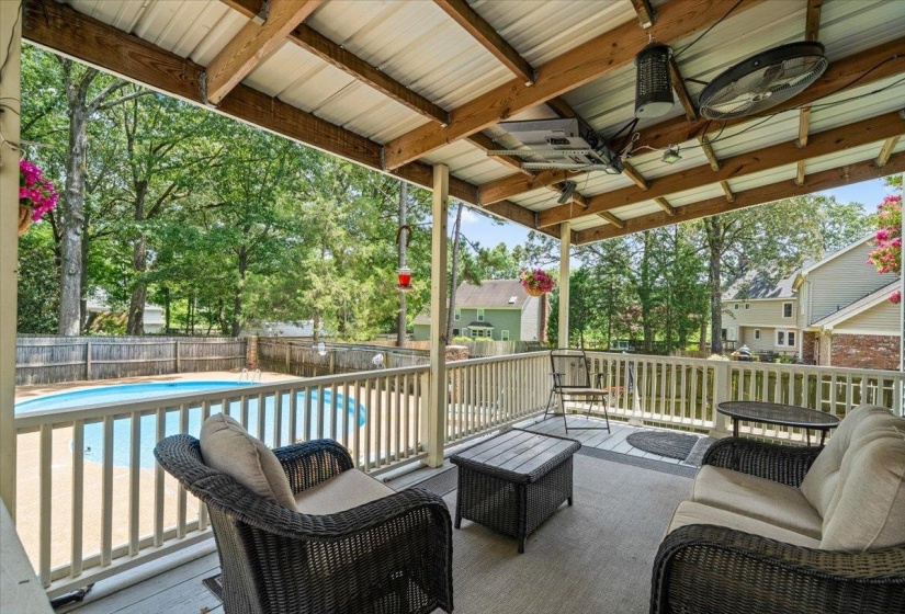 Fenced backyard featuring ceiling fan and a deck