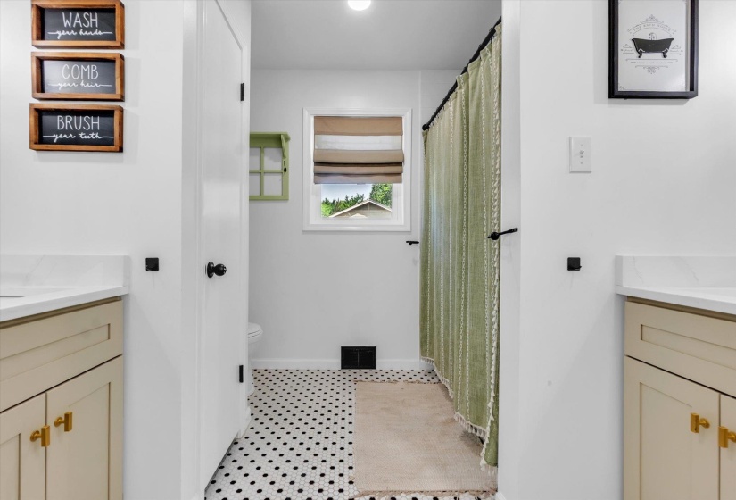 Bathroom featuring vanity and a shower with shower curtain