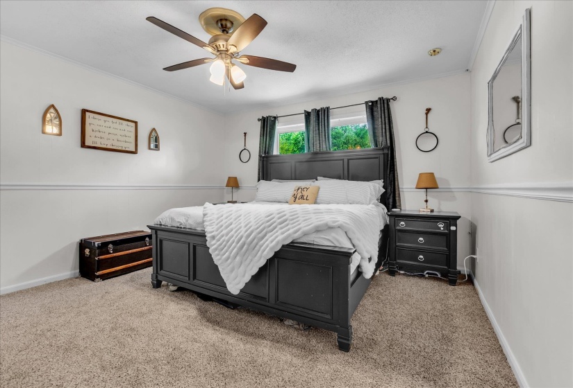 Bedroom featuring crown molding, ceiling fan, and carpet flooring