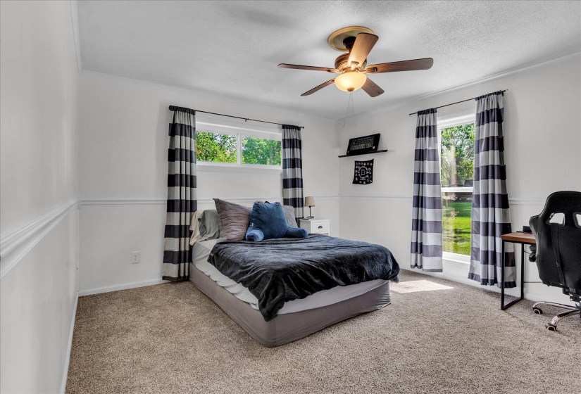 Carpeted bedroom with ceiling fan