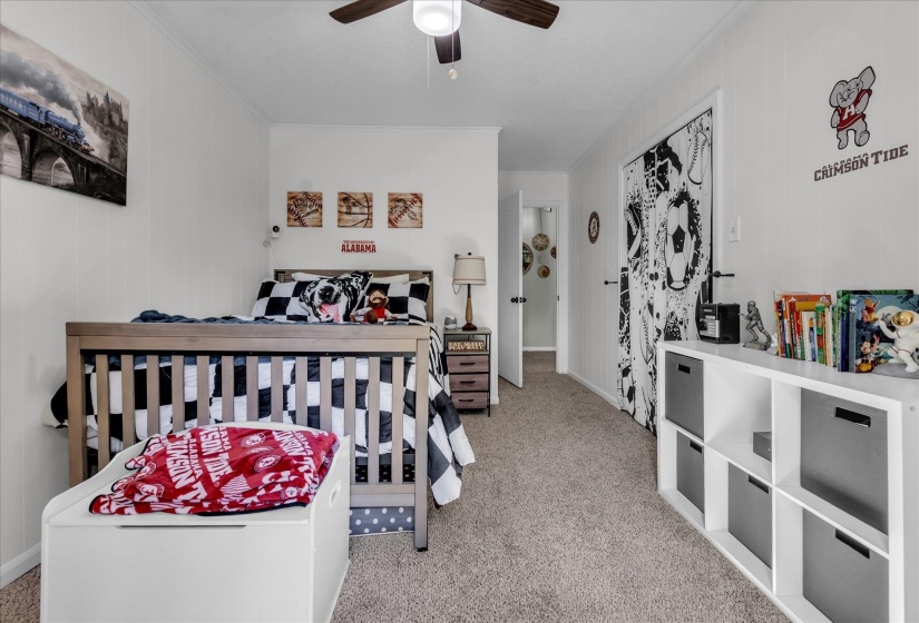 Bedroom featuring light carpet, ceiling fan, and crown molding