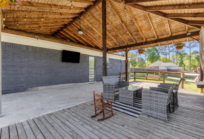 Wooden terrace featuring an outdoor living space and a patio area