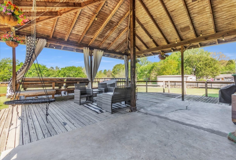 Wooden terrace featuring an outdoor hangout area, area for grilling, a patio area, and a yard