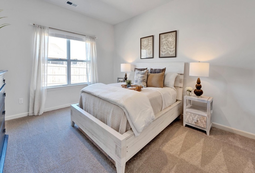 Bedroom featuring baseboards and light colored carpet