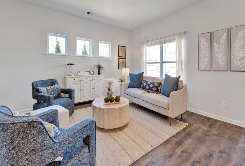 Living area with wood finished floors and baseboards